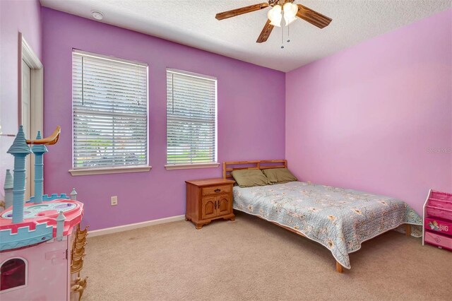 1 Rockwell Ln W, Palm Coast, FL 32164 - carpeted bedroom with a textured ceiling, ceiling fan, and baseboards