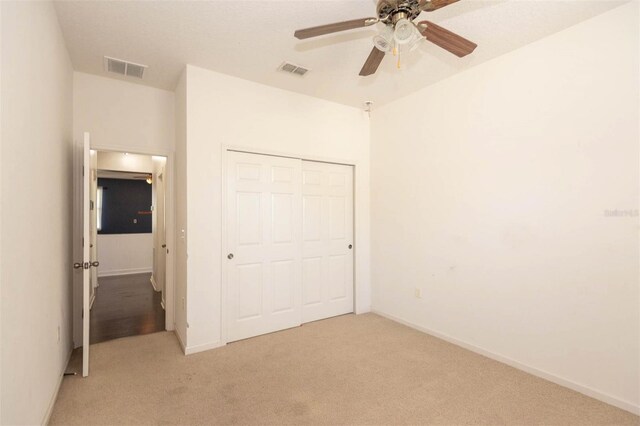 1 Rockwell Ln W, Palm Coast, FL 32164 - unfurnished bedroom featuring light carpet, a closet, baseboards, and ceiling fan