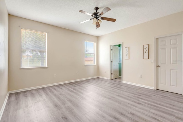 1 Rockwell Ln W, Palm Coast, FL 32164 - spare room featuring light wood-style floors, ceiling fan, a textured ceiling, and baseboards