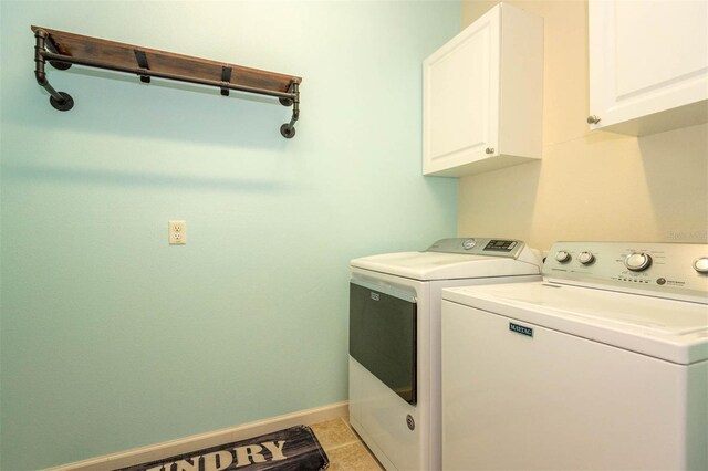1 Rockwell Ln W, Palm Coast, FL 32164 - laundry area with cabinet space, washing machine and clothes dryer, and baseboards