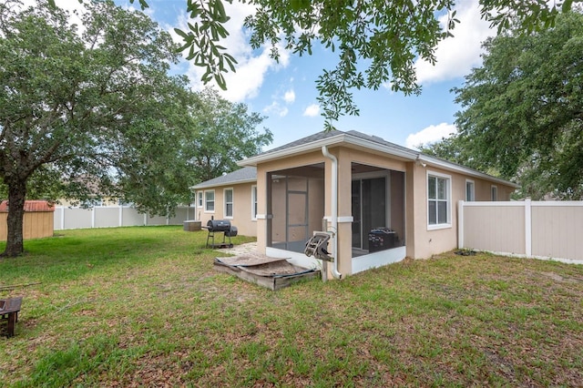 1 Rockwell Ln W, Palm Coast, FL 32164 - rear view of house with a sunroom and stucco siding