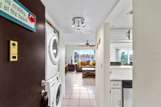 3600 S Ocean Shore Blvd Unit 222, Flagler Beach, FL 32136 - laundry room featuring stacked washer and clothes dryer, light tile patterned flooring, and a ceiling fan
