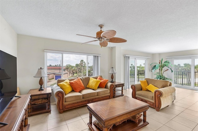 3600 S Ocean Shore Blvd Unit 222, Flagler Beach, FL 32136 - living room with light tile patterned floors, ceiling fan, healthy amount of natural light, and a textured ceiling
