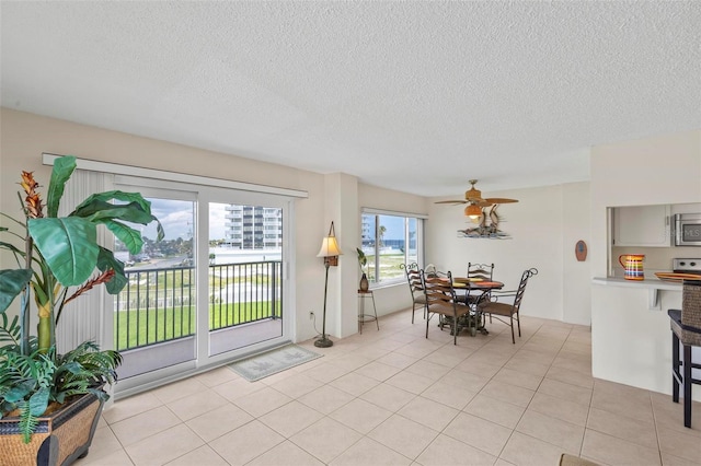 3600 S Ocean Shore Blvd Unit 222, Flagler Beach, FL 32136 - dining area with a textured ceiling, a ceiling fan, and light tile patterned flooring