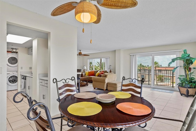 3600 S Ocean Shore Blvd Unit 222, Flagler Beach, FL 32136 - dining area featuring stacked washer / dryer, a ceiling fan, light tile patterned flooring, a skylight, and a textured ceiling