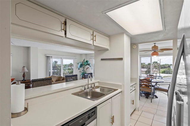 3600 S Ocean Shore Blvd Unit 222, Flagler Beach, FL 32136 - kitchen featuring a sink, light countertops, light tile patterned floors, white cabinets, and dishwashing machine