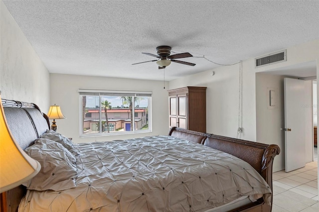 3600 S Ocean Shore Blvd Unit 222, Flagler Beach, FL 32136 - bedroom with light tile patterned floors, a textured ceiling, and ceiling fan
