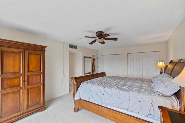 3600 S Ocean Shore Blvd Unit 222, Flagler Beach, FL 32136 - bedroom featuring two closets, light tile patterned floors, and a ceiling fan