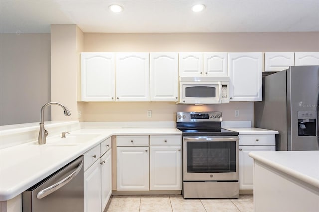 1100 Canopy Walk Ln Unit 1113, Palm Coast, FL 32137 - kitchen featuring appliances with stainless steel finishes, white cabinets, a sink, light countertops, and light tile patterned flooring