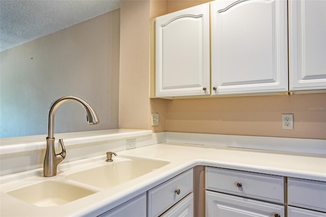 1100 Canopy Walk Ln Unit 1113, Palm Coast, FL 32137 - kitchen featuring a sink, white cabinetry, light countertops, and a textured ceiling