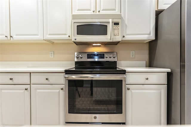 1100 Canopy Walk Ln Unit 1113, Palm Coast, FL 32137 - kitchen featuring appliances with stainless steel finishes, white cabinetry, and light countertops