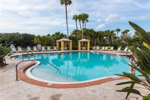 1100 Canopy Walk Ln Unit 1113, Palm Coast, FL 32137 - community pool featuring a patio area, view of scattered trees, and a gazebo