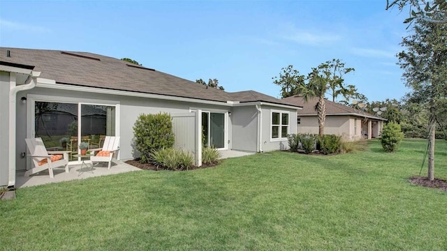 115 Wellwood Ln Unit A, Palm Coast, FL 32164 - rear view of house featuring a yard, a patio, and stucco siding