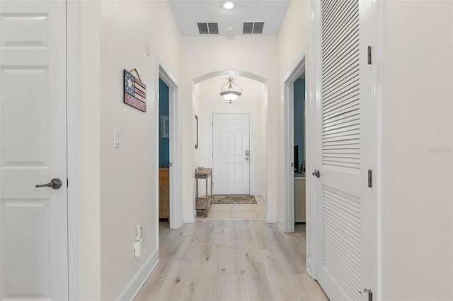 1200 Cinnamon Beach Way Unit 1133, Palm Coast, FL 32137 - hallway featuring arched walkways, light wood finished floors, and baseboards