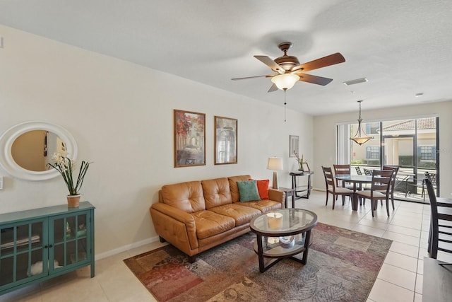 300 Via Castilla Unit 103, Saint Augustine, FL 32095 - living area with light tile patterned floors, ceiling fan, and baseboards