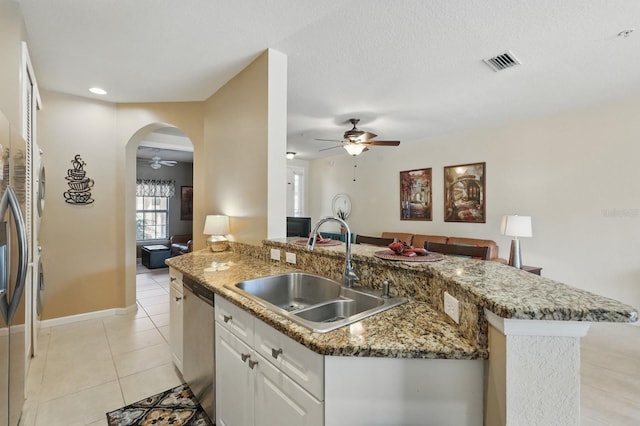 300 Via Castilla Unit 103, Saint Augustine, FL 32095 - kitchen featuring ceiling fan, a sink, stainless steel appliances, light tile patterned floors, and stone counters