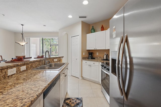 300 Via Castilla Unit 103, Saint Augustine, FL 32095 - kitchen with appliances with stainless steel finishes, a sink, white cabinetry, pendant lighting, and recessed lighting