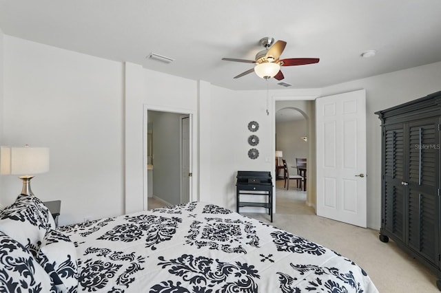 300 Via Castilla Unit 103, Saint Augustine, FL 32095 - bedroom with light colored carpet, arched walkways, and a ceiling fan
