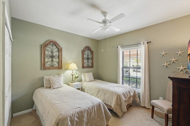 300 Via Castilla Unit 103, Saint Augustine, FL 32095 - bedroom featuring light carpet, ceiling fan, and baseboards