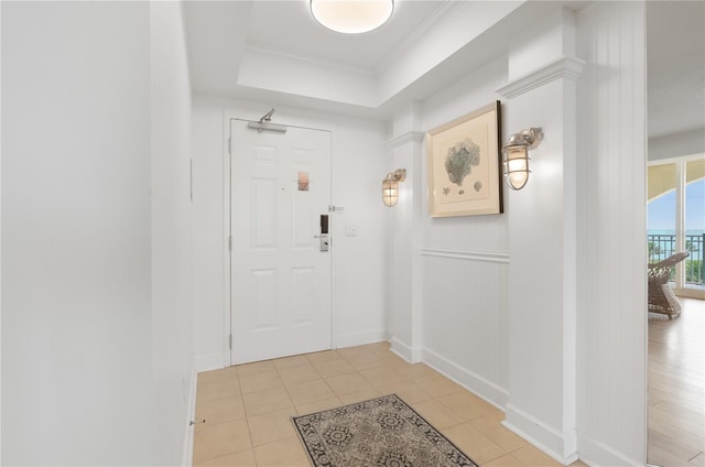 200 Ocean Crest Dr Unit 605, Palm Coast, FL 32137 - entryway featuring light tile patterned floors, ornamental molding, and a tray ceiling