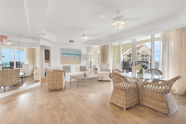 200 Ocean Crest Dr Unit 605, Palm Coast, FL 32137 - dining space featuring a ceiling fan, wood finished floors, and ornamental molding