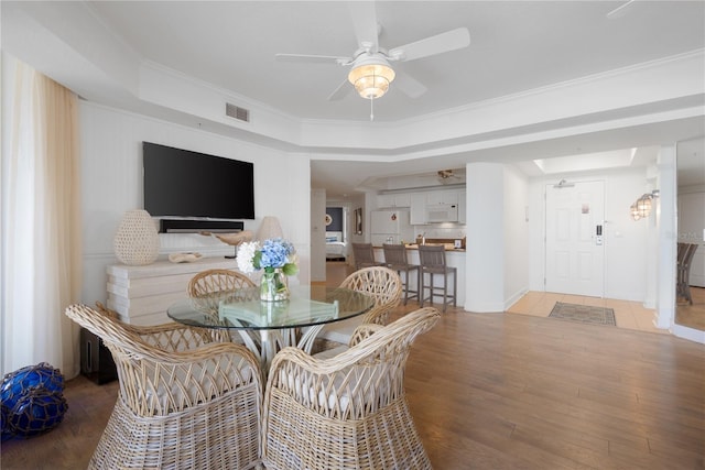 200 Ocean Crest Dr Unit 605, Palm Coast, FL 32137 - dining space with ceiling fan, light wood-style flooring, a tray ceiling, and crown molding