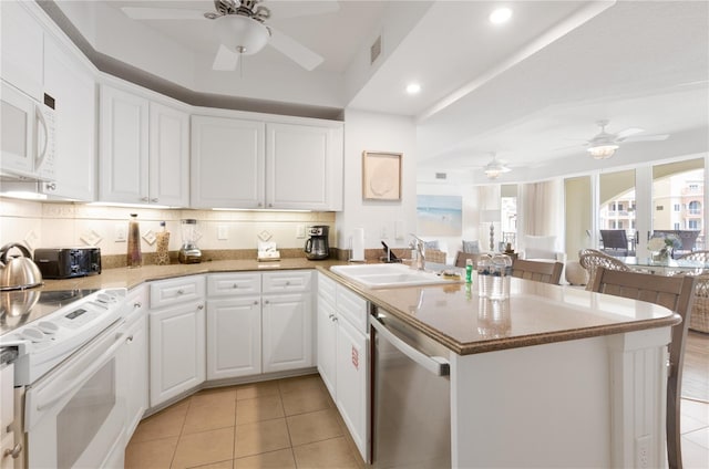 200 Ocean Crest Dr Unit 605, Palm Coast, FL 32137 - kitchen featuring white appliances, ceiling fan, a peninsula, light tile patterned floors, and recessed lighting