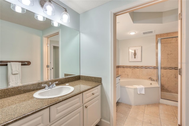 200 Ocean Crest Dr Unit 605, Palm Coast, FL 32137 - full bathroom with a garden tub, vanity, tile patterned floors, and a stall shower