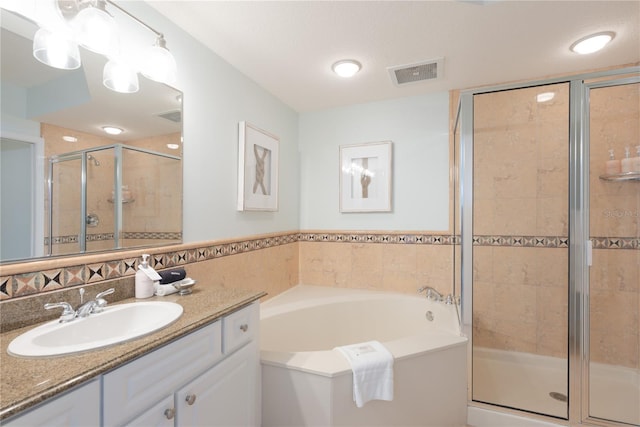 200 Ocean Crest Dr Unit 605, Palm Coast, FL 32137 - bathroom with vanity, a garden tub, and a shower stall