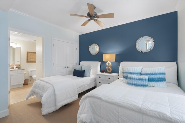 200 Ocean Crest Dr Unit 605, Palm Coast, FL 32137 - bedroom featuring crown molding, a closet, connected bathroom, a ceiling fan, and carpet flooring