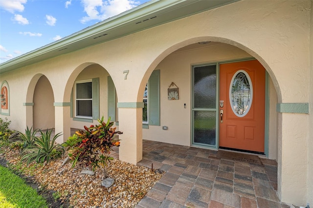 7 Fleming Ct, Palm Coast, FL 32137 - property entrance featuring stucco siding and covered porch