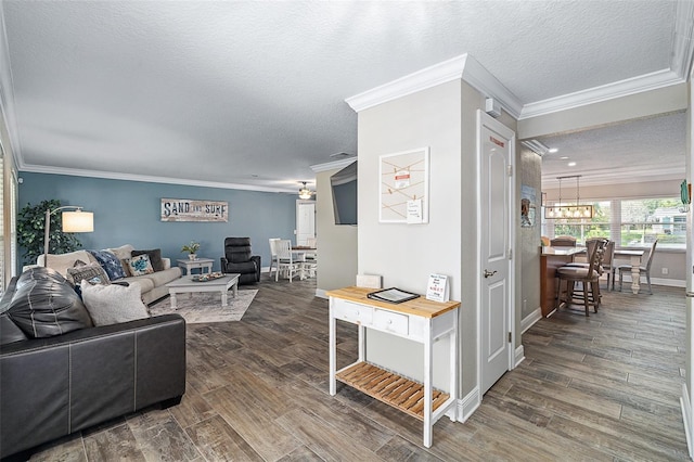 7 Fleming Ct, Palm Coast, FL 32137 - living area featuring ornamental molding, a textured ceiling, dark wood-style flooring, a chandelier, and baseboards