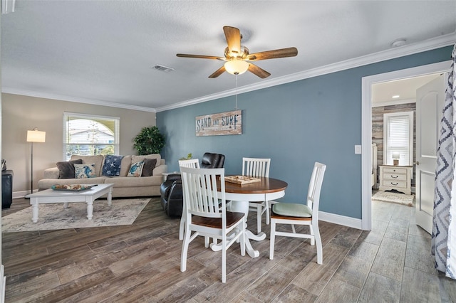 7 Fleming Ct, Palm Coast, FL 32137 - dining area featuring a ceiling fan, wood finished floors, crown molding, and baseboards