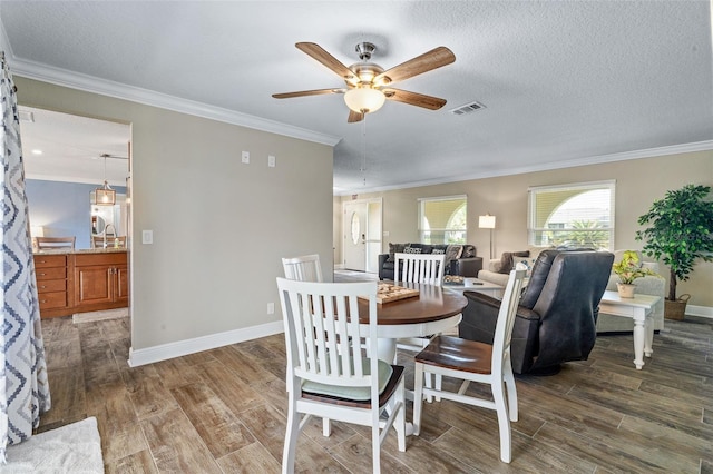 7 Fleming Ct, Palm Coast, FL 32137 - dining area featuring wood finished floors, ceiling fan, baseboards, and crown molding