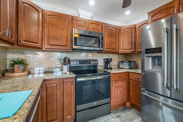 7 Fleming Ct, Palm Coast, FL 32137 - kitchen featuring appliances with stainless steel finishes, brown cabinetry, light stone countertops, and decorative backsplash