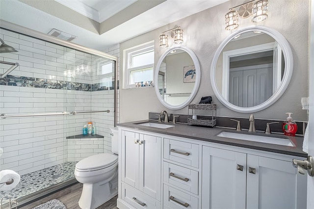 7 Fleming Ct, Palm Coast, FL 32137 - bathroom featuring ornamental molding, a shower stall, double vanity, toilet, and wood finished floors