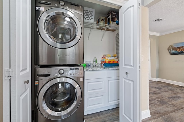 7 Fleming Ct, Palm Coast, FL 32137 - laundry room with estacked washer and dryer, dark wood-style floors, crown molding, a textured ceiling, and baseboards