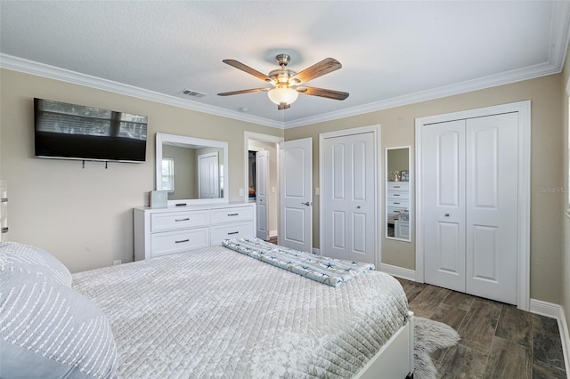 7 Fleming Ct, Palm Coast, FL 32137 - bedroom featuring multiple closets, crown molding, dark wood finished floors, a ceiling fan, and baseboards