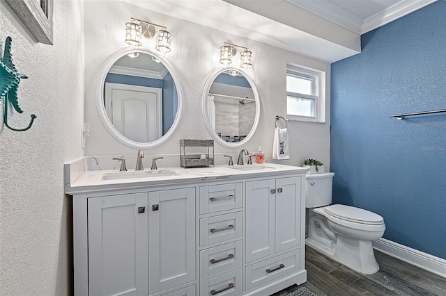 7 Fleming Ct, Palm Coast, FL 32137 - bathroom featuring crown molding, double vanity, toilet, a textured wall, and wood finished floors