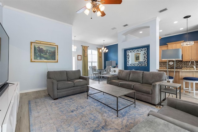 115 Bay Lake Dr, Ormond Beach, FL 32174 - living area with a chandelier, a ceiling fan, light wood-type flooring, crown molding, and recessed lighting