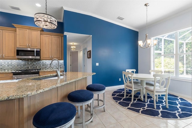 115 Bay Lake Dr, Ormond Beach, FL 32174 - kitchen with stainless steel appliances, a chandelier, a sink, plenty of natural light, and crown molding