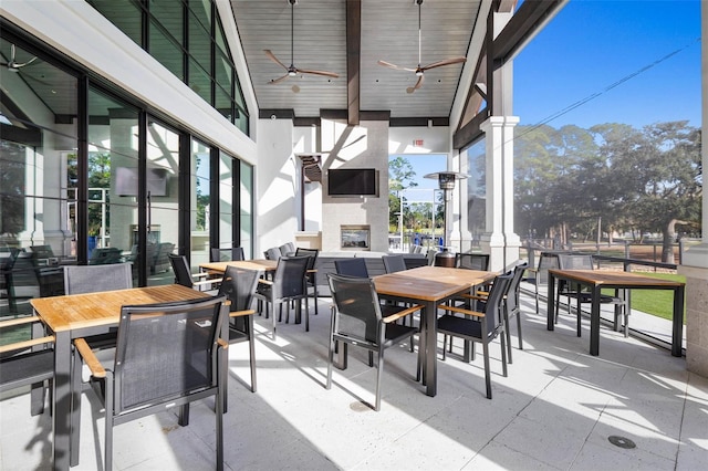 115 Bay Lake Dr, Ormond Beach, FL 32174 - view of patio with an outdoor fireplace, outdoor dining area, and a ceiling fan