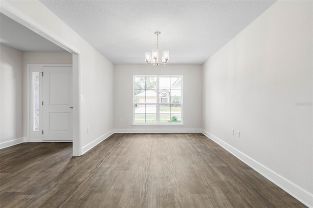 6 Squanto Pl, Palm Coast, FL 32164 - empty room featuring a chandelier, dark wood-style flooring, and baseboards