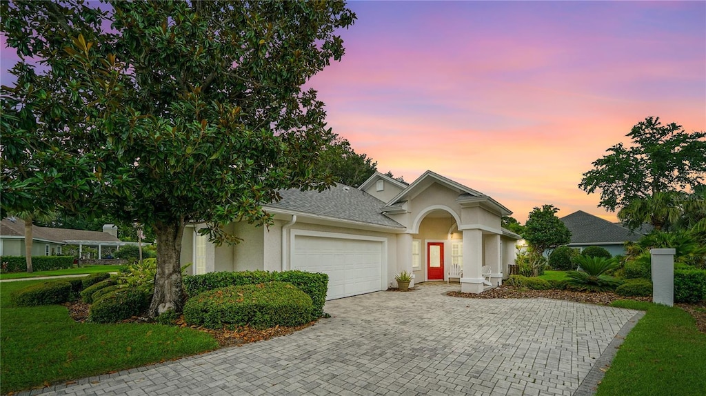 702 Divot Ct, Saint Augustine, FL 32080 - ranch-style home with a garage, stucco siding, driveway, and a front lawn