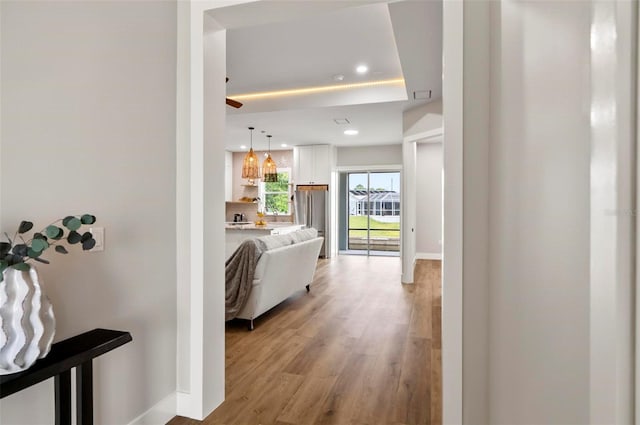 56 Columbia Ln, Palm Coast, FL 32137 - hallway featuring recessed lighting, light wood-style flooring, and a tray ceiling