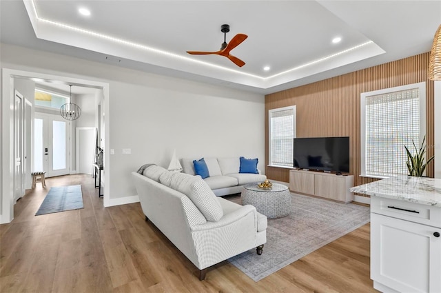 56 Columbia Ln, Palm Coast, FL 32137 - living area featuring a raised ceiling, light wood-style flooring, a chandelier, plenty of natural light, and recessed lighting