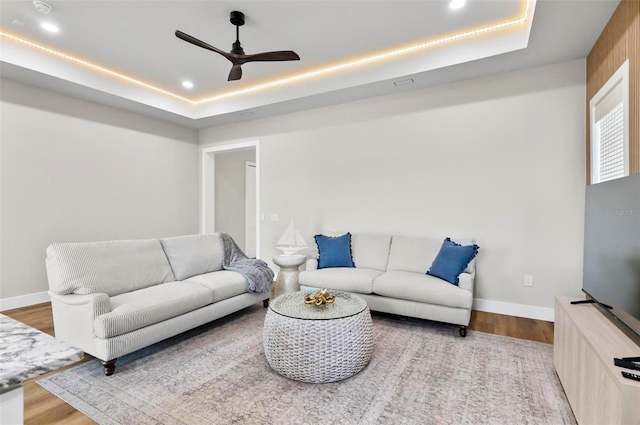 56 Columbia Ln, Palm Coast, FL 32137 - living room featuring a raised ceiling, a ceiling fan, wood finished floors, and recessed lighting