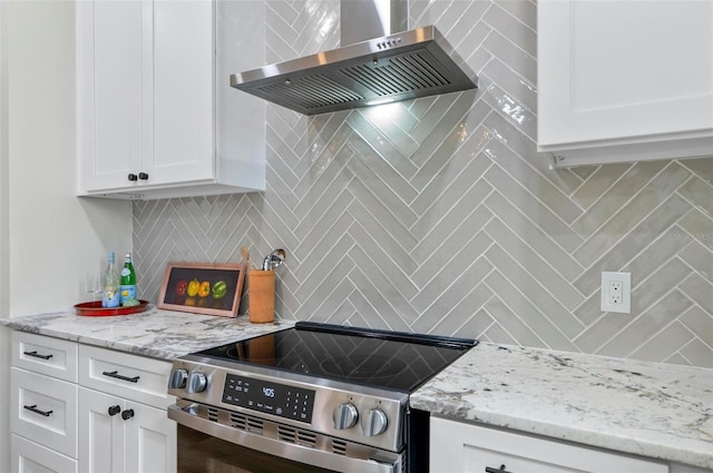 56 Columbia Ln, Palm Coast, FL 32137 - kitchen with wall chimney range hood, electric range, decorative backsplash, white cabinetry, and light stone counters