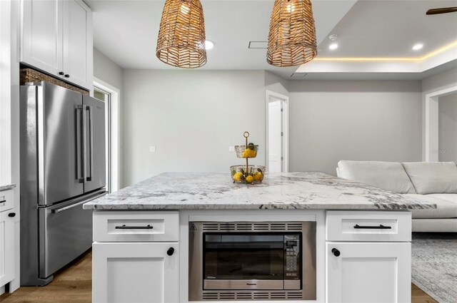 56 Columbia Ln, Palm Coast, FL 32137 - kitchen with stainless steel appliances, dark wood-style floors, open floor plan, white cabinets, and recessed lighting
