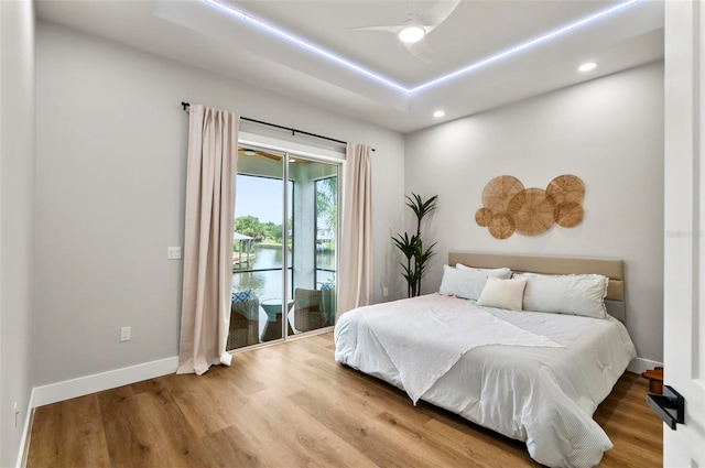 56 Columbia Ln, Palm Coast, FL 32137 - bedroom featuring access to outside, recessed lighting, wood finished floors, ceiling fan, and a water view